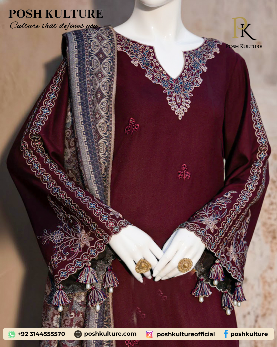 Mannequin wearing a deep red/maroon embroidered Dhanak shirt with plain trousers and a richly printed soft wool shawl, set against an outdoor background.