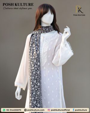 3-piece white Dhanak suit featuring subtle white-on-white embroidery on the shirt, paired with a high-contrast black and white floral-printed luxury wool shawl for the winter 2025 collection.
